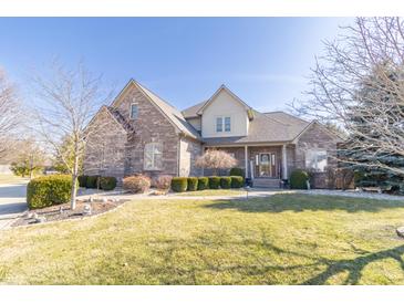 Charming two-story brick home with a welcoming front porch and well-maintained lawn at 1115 Morningside Ct, Greenfield, IN 46140