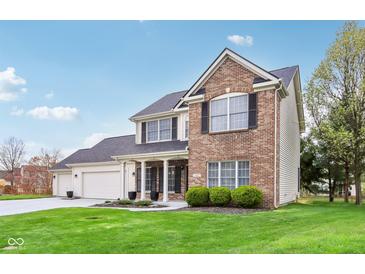 Charming two-story home with brick and siding, complemented by a lush green lawn and inviting curb appeal at 11907 Ledgestone Cir, Fishers, IN 46037