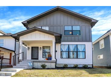 Charming two-story home featuring a modern design, covered front porch, and gray and white color scheme at 1603 Nowland Ave, Indianapolis, IN 46201