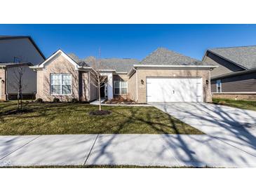 Inviting single-story home featuring a brick facade, attached two-car garage, and well-maintained lawn at 2352 Somerset Cir, Franklin, IN 46131