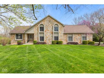 Charming stone-front home with a well-manicured lawn, mature landscaping, and a welcoming entrance at 241 Melissa Ann Ct, Indianapolis, IN 46234
