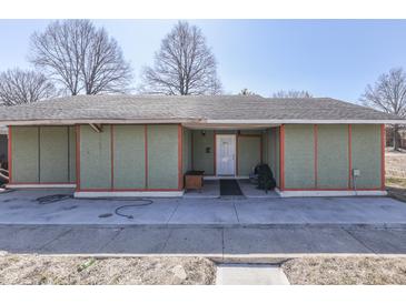 Exterior view of single-story home with concrete porch and yard featuring mature trees on a sunny day at 3652 Yellow Poplar Ct, Indianapolis, IN 46222