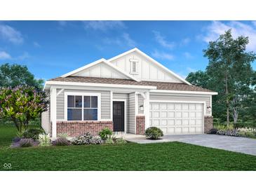Charming single-story home with a manicured lawn, gray siding, and a welcoming front entrance, blending style and comfort at 3769 Cantebury Dr, Franklin, IN 46131