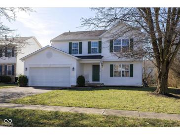 Charming two-story home with a well-maintained lawn, attached two-car garage, and a classic green door at 6513 Kingsbury Way, Zionsville, IN 46077
