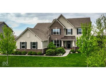 Beautiful two-story home with brick and siding exterior, professional landscaping, and lush green lawn at 12127 Whisper Ridge Dr, Noblesville, IN 46060