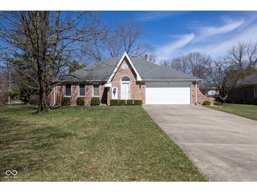 Charming brick home featuring a two-car garage and well-manicured front yard at 154 Dover N Blvd, Brownsburg, IN 46112
