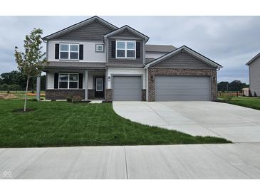 Charming two-story home with a two-car garage, manicured lawn, and a welcoming front entrance at 2290 Oakmont Dr, Plainfield, IN 46168