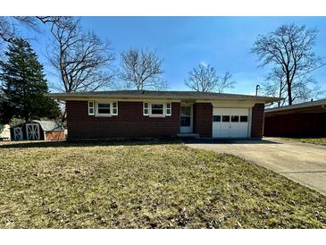 Charming single-story brick home with an attached garage and well-kept lawn on a sunny day at 5850 Paradise Ln, Martinsville, IN 46151