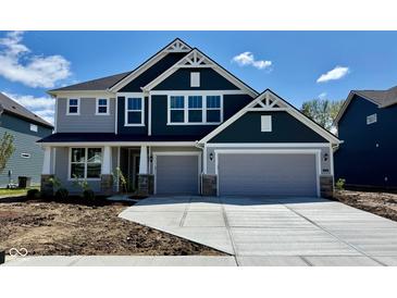 Charming two-story home showcasing a spacious two-car garage and a beautifully designed exterior at 8445 Morgan Ln, Zionsville, IN 46077