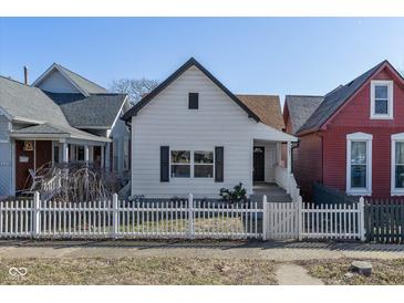 Charming home featuring white picket fence, inviting curb appeal, and a classic design at 1129 Church St, Indianapolis, IN 46225