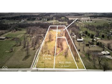 Expansive aerial view showcasing a vast property with distinct land parcels and a serene pond at 15123 E 196Th St, Noblesville, IN 46060