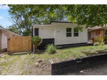 View of the side and front of the home, showing the freshly painted exterior at 516 N Chester Ave, Indianapolis, IN 46201