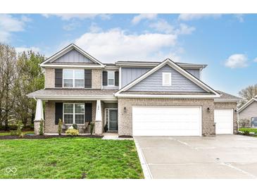 Charming two-story home with brick facade, attached garage, and well-manicured lawn at 698 Ridge Gate Dr, Brownsburg, IN 46112