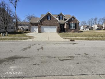 Charming two-story brick home featuring a two-car garage and well-maintained landscaping at 720 Erin Dr, Avon, IN 46123