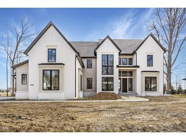 Stunning new construction home with a painted brick exterior and black trim windows at 3787 Cherwell Dr, Zionsville, IN 46077