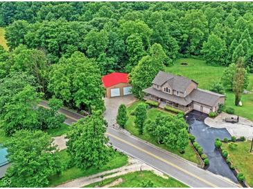 Sprawling country home on an expansive lot with mature trees and a detached garage at 4590 Turkey Track Rd, Martinsville, IN 46151