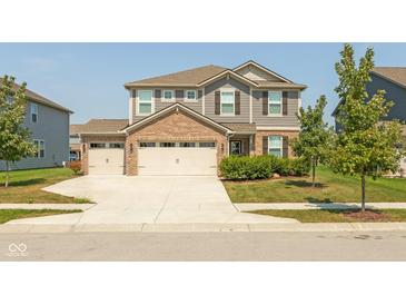 Beautiful two-story home with a well-manicured lawn, a three-car garage, and a brick-and-siding facade at 9709 Tampico Chase, Fishers, IN 46040