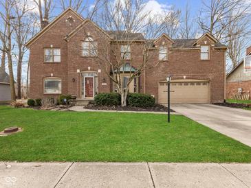 Beautiful brick two-story home with a well-manicured lawn and attached two car garage at 10145 Northwind Dr, Indianapolis, IN 46256