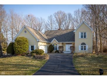 Charming yellow home with well-manicured lawn and inviting driveway at 12348 Seaway Cir, Indianapolis, IN 46236
