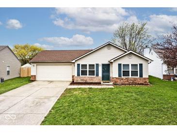 Charming single-story home with a two-car garage, brick accents, and well-maintained lawn at 1378 Millridge Dr, Greenwood, IN 46143