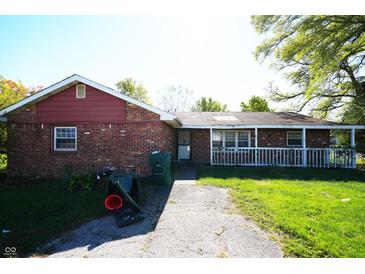 Cozy brick home with a covered porch and a narrow walkway in a charming neighborhood at 1509 E Centennial Ave, Muncie, IN 47303
