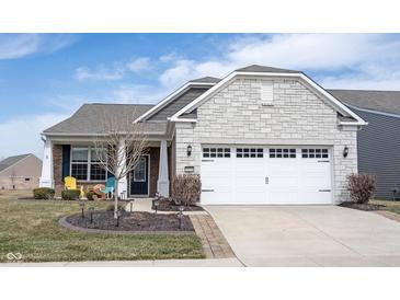 Charming home featuring stone accents, two-car garage, and manicured front lawn adding curb appeal at 16164 Loire Valley Dr, Fishers, IN 46037