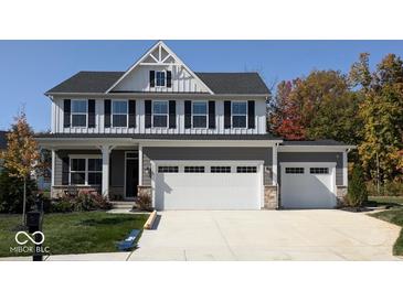 Beautiful two-story home featuring a 2-car garage, gray siding, black shutters and a covered front porch at 2882 Simsbury Ln, Brownsburg, IN 46112