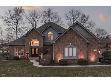 Charming brick home with manicured lawn, beautiful windows and inviting entryway at 4140 Sagewood Ct, Greenwood, IN 46143