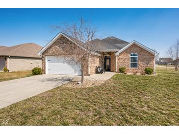 Charming single-story home featuring a brick exterior, attached garage, and well-maintained lawn at 4347 Westminster Pl, Columbus, IN 47201