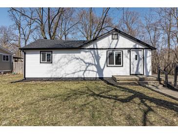 Charming home featuring white siding, black trim, and a well-maintained lawn at 7252 E 47Th St, Indianapolis, IN 46226
