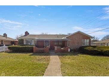 Charming brick home with a covered front porch and well-maintained landscaping at 847 Churchman Ave, Beech Grove, IN 46107