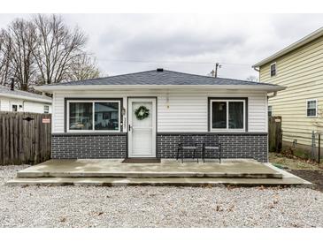 Charming single-story home featuring a well-kept yard and inviting front porch with modern colors at 3867 Asbury St, Indianapolis, IN 46227