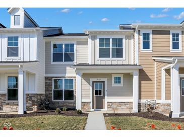 Charming new two-story townhouse with stone accents and a well-maintained lawn under a bright blue sky at 3923 Wren Dr, Brownsburg, IN 46112