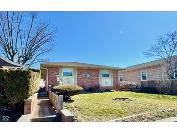 Charming single-story brick home featuring a well-maintained lawn and a cozy, inviting entrance at 75 S 11Th Ave, Beech Grove, IN 46107