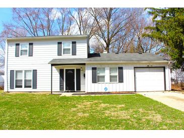 Charming two-story home with a well-maintained lawn and classic curb appeal enhanced by dark shutters and door at 9238 Celtic Ct, Indianapolis, IN 46235