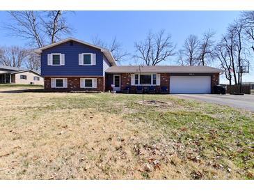 Charming two-story home with brick accents and a well-maintained front yard on a sunny day at 425 Conduitt Dr, Mooresville, IN 46158
