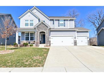Charming two-story home with stone accents and a spacious three car garage in a suburban neighborhood at 655 Bracknell Dr, Avon, IN 46123