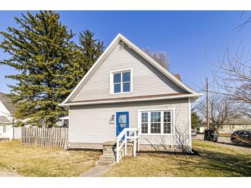 Charming house featuring light siding, a blue front door, and a well-maintained front yard at 821 S Lebanon St, Lebanon, IN 46052
