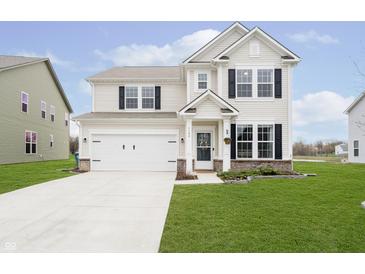 Charming two-story home with a well-manicured lawn and attached two car garage at 1142 Cobra Dr, Franklin, IN 46131