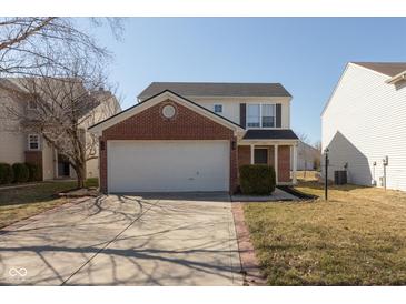 Two-story home featuring brick and siding, attached two car garage, and manicured lawn at 15405 Fawn Meadow Dr, Noblesville, IN 46060