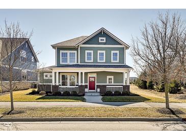 Charming two-story home featuring a inviting front porch, well-manicured lawn and appealing curb appeal at 1591 W 151St St, Westfield, IN 46074
