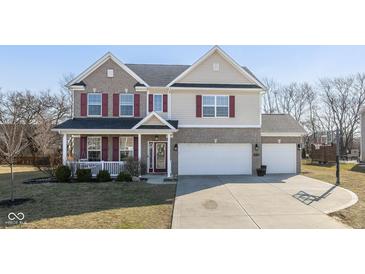 Charming two-story home features a spacious three-car garage, cozy front porch, and brick and siding exterior at 1773 Winchester Blvd, Avon, IN 46123