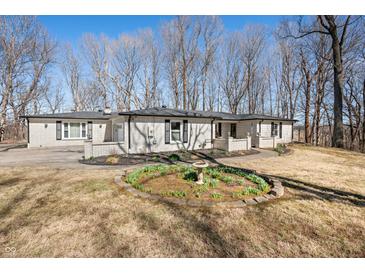 Charming white brick home with black shutters and a well-manicured lawn at 2408 E Stafford Pl, Martinsville, IN 46151