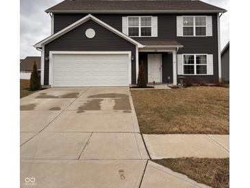 Charming two-story home featuring a two-car garage, well-maintained lawn, and classic architectural details at 298 Rocky Rd, Greenfield, IN 46140