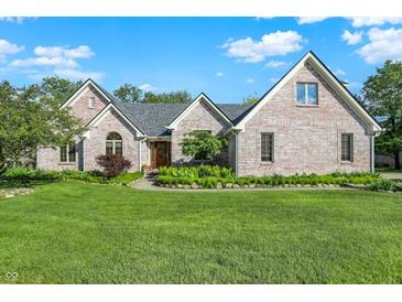 Charming brick home with a well-manicured lawn and lush landscaping creates inviting curb appeal at 37 Trotters Run, Brownsburg, IN 46112