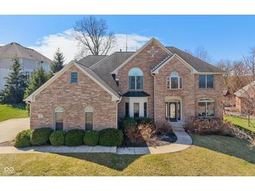 Stately two-story brick home featuring manicured landscaping and a welcoming entrance at 5517 Westbourne Ct, Greenwood, IN 46143