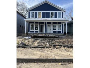 Two-story navy home features white trim, modern windows, and a welcoming front porch at 617 W 39Th St, Indianapolis, IN 46208