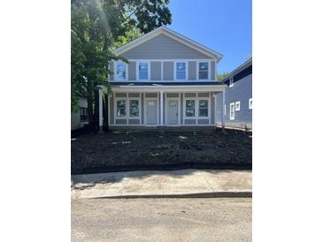 New construction two-story home with gray siding, white trim, and large windows at 617 W 39Th St, Indianapolis, IN 46208