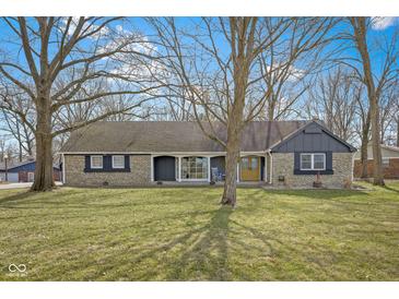 Charming single-story home featuring stone accents and a well-manicured front lawn at 6201 S Carroll Rd, Indianapolis, IN 46259