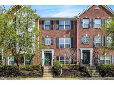 Charming brick townhome featuring classic architectural details and well-maintained landscaping at 918 Rosalind Pl, Carmel, IN 46032